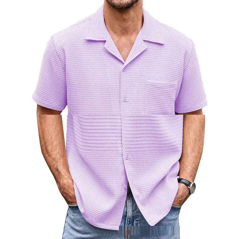 Man wearing a lilac waffle knit short sleeve shirt with collar and front pocket