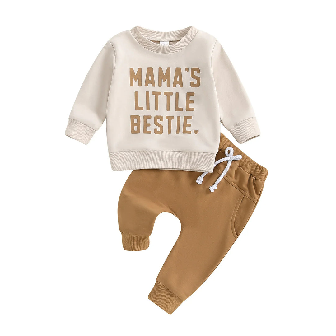 Beige baby sweatshirt with "Mama's Little Bestie" text and brown pants with a white drawstring