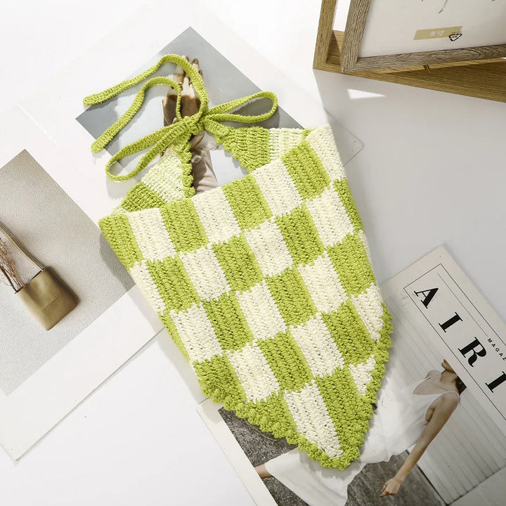 Green and white crochet halter top with checkerboard pattern on magazine pages