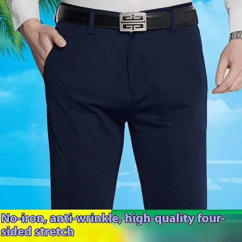Man wearing navy blue no-iron, anti-wrinkle, high-quality stretch pants with black belt against blue sky background