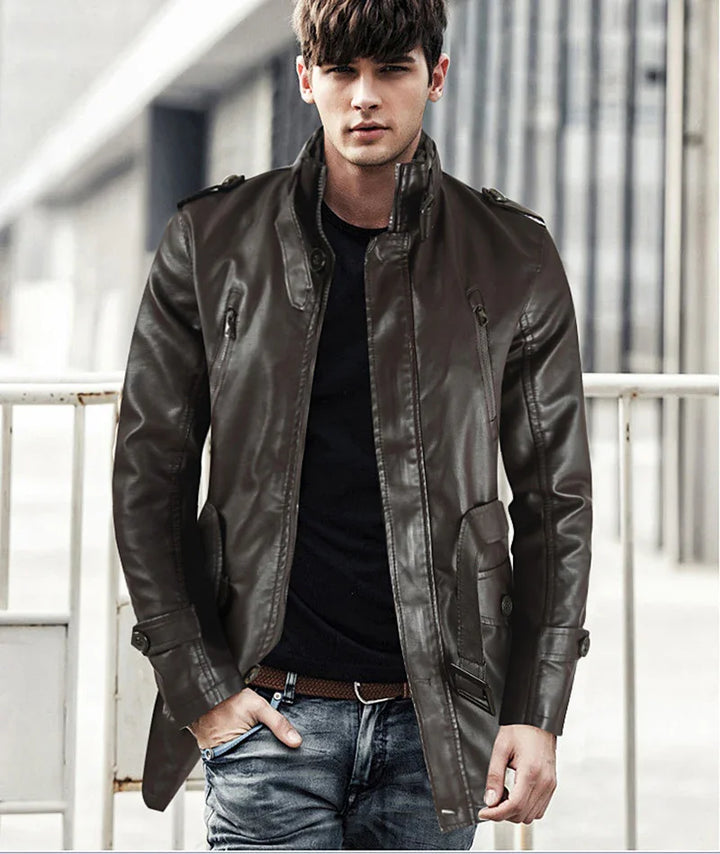 Young man wearing a dark brown leather jacket, black shirt, and jeans in an urban outdoor setting