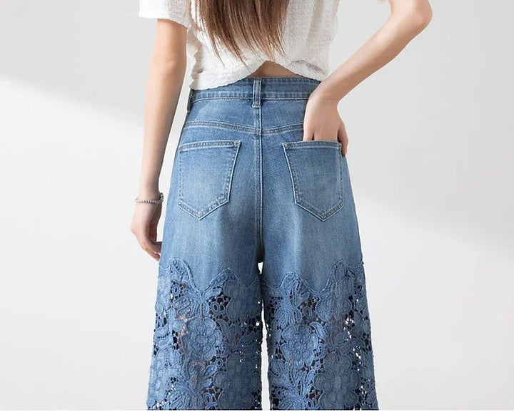 Back view of woman wearing blue denim jeans with floral lace cutout design on lower legs