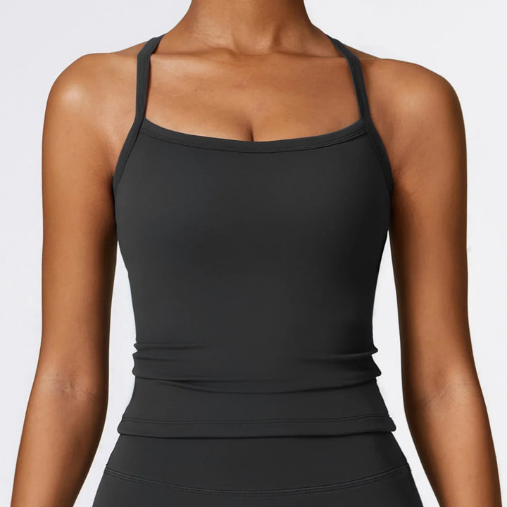 Close-up of woman wearing black fitted tank top with thin straps on bare shoulders