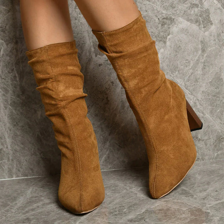 brown suede slouchy mid-calf boots with chunky wooden heels on marble floor