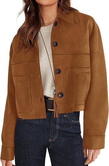 woman wearing brown suede cropped jacket with black buttons and front pockets, paired with white top and dark blue jeans