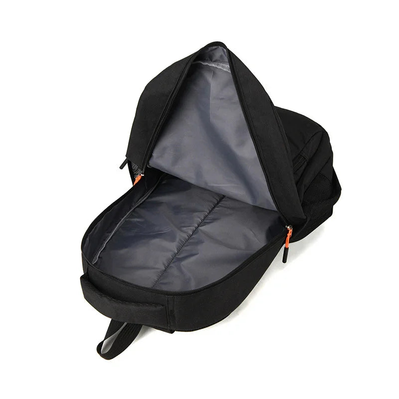 black backpack with open main compartment showing gray interior and orange zipper pulls