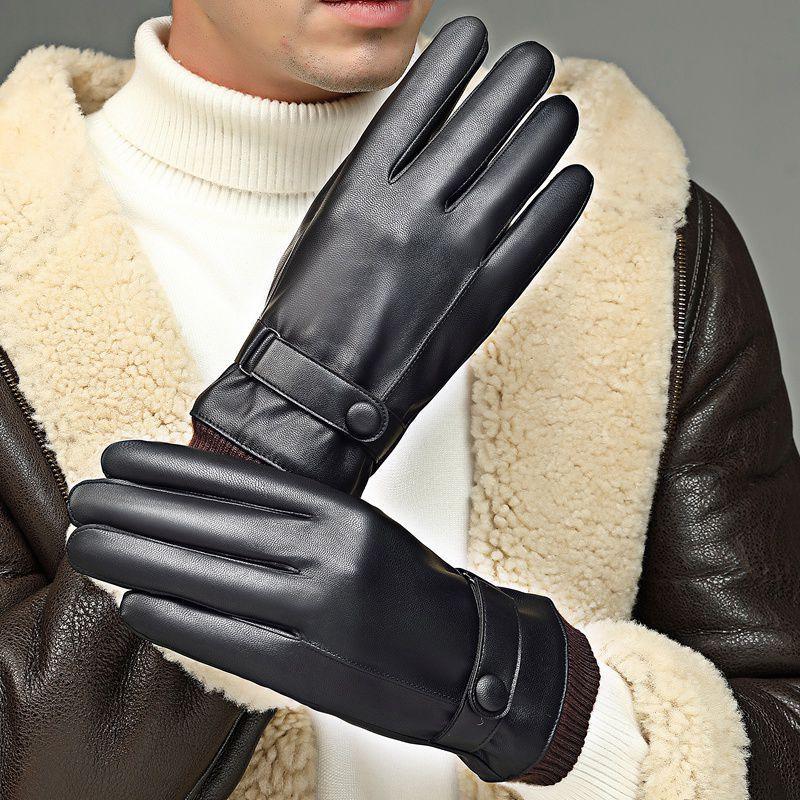 Man wearing black leather winter gloves with button strap, shearling jacket, and white turtleneck sweater