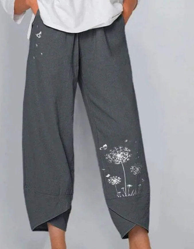 Gray casual cropped pants with white floral dandelion print and overlapping hems