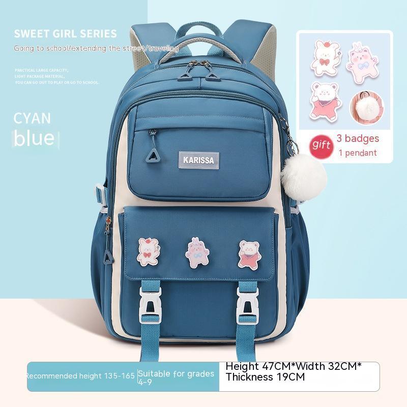 Cyan blue KARISSA girls' school backpack with multiple pockets, decorative badges, and a fluffy pendant