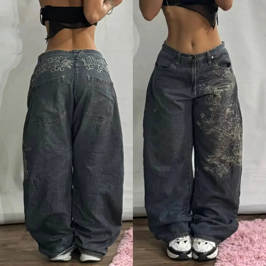 Front and back views of black baggy jeans with white embroidery worn with sneakers
