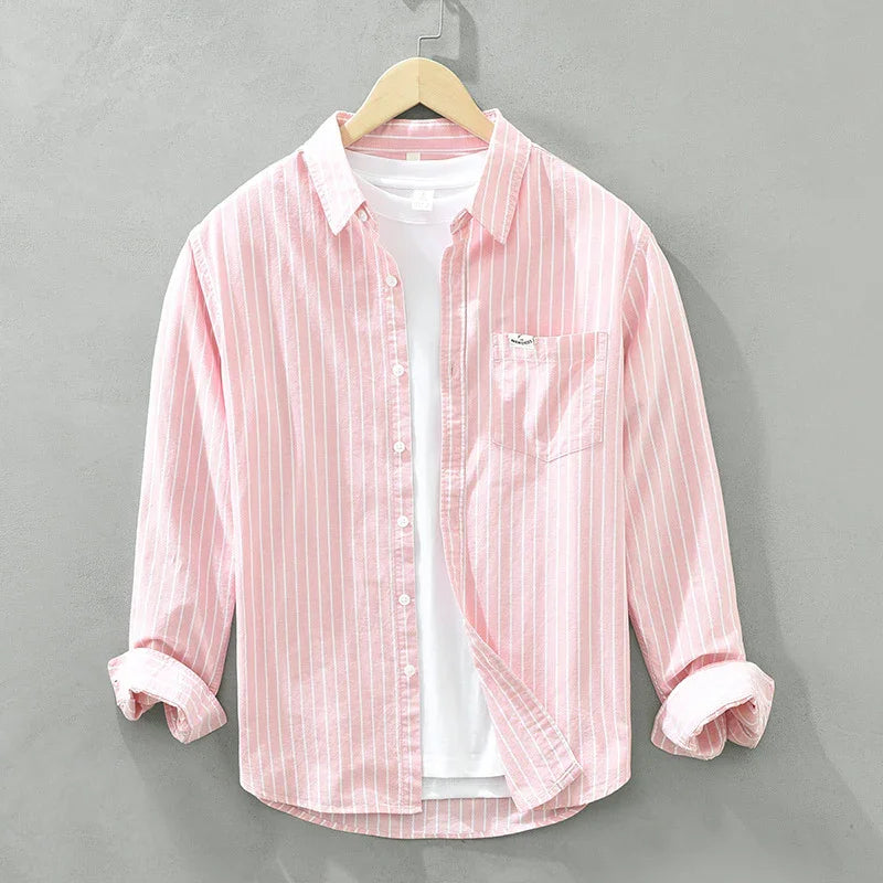 Pink and white striped casual shirt with rolled sleeves and white undershirt on hanger