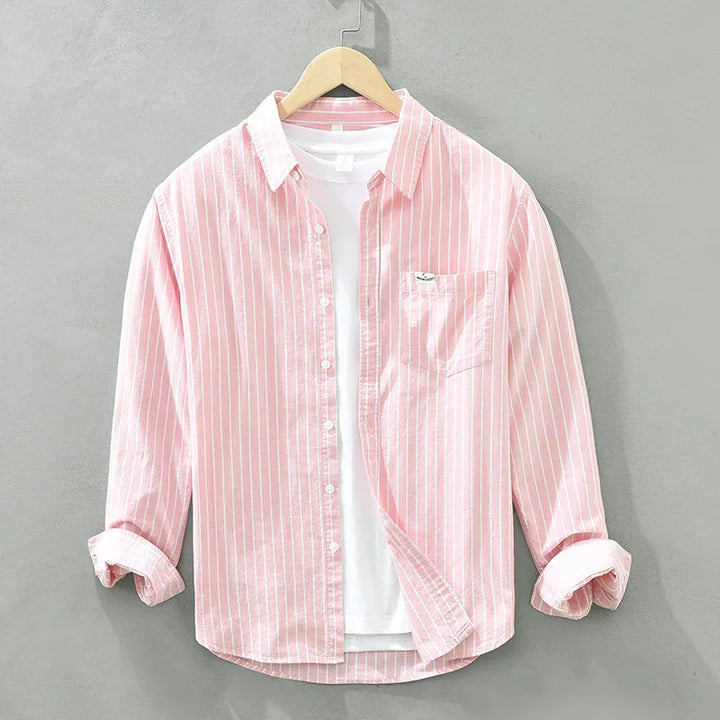 Pink and white striped casual shirt with rolled sleeves and white undershirt on hanger