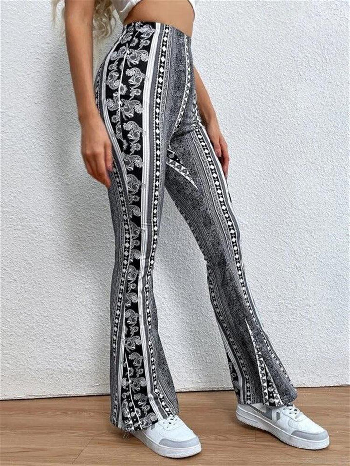 Woman wearing black and white patterned high-waist flare pants with white sneakers