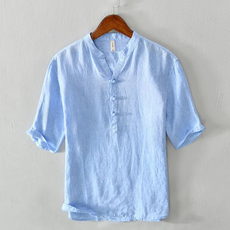 Light blue linen casual shirt with mandarin collar and short sleeves on wooden hanger