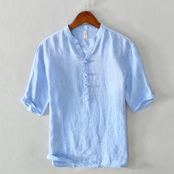 Light blue linen casual shirt with mandarin collar and short sleeves on wooden hanger