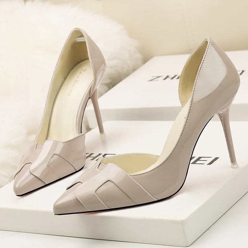 Elegant beige patent leather high heel pumps with pointed toes displayed on white boxes