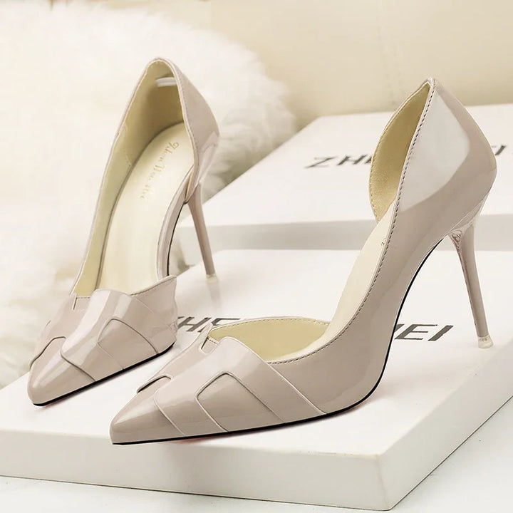 Elegant beige patent leather high heel pumps with pointed toes displayed on white boxes