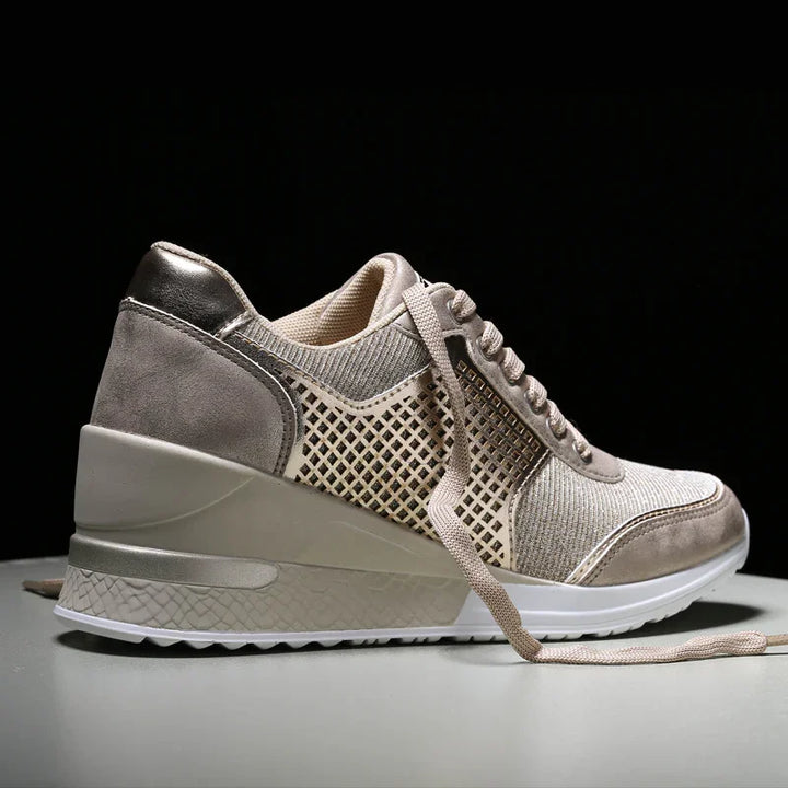 Beige wedge sneaker with mesh and suede details, beige laces, and white textured sole