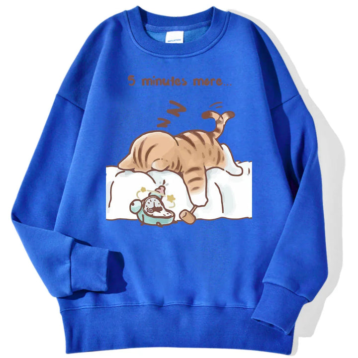 Blue sweatshirt with cartoon cat sleeping on bed and alarm clock, text saying '5 minutes more'