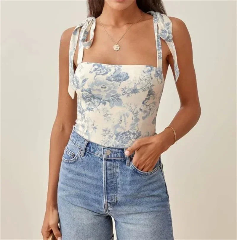 Woman wearing floral print tie shoulder tank top with high-waisted blue jeans casual outfit