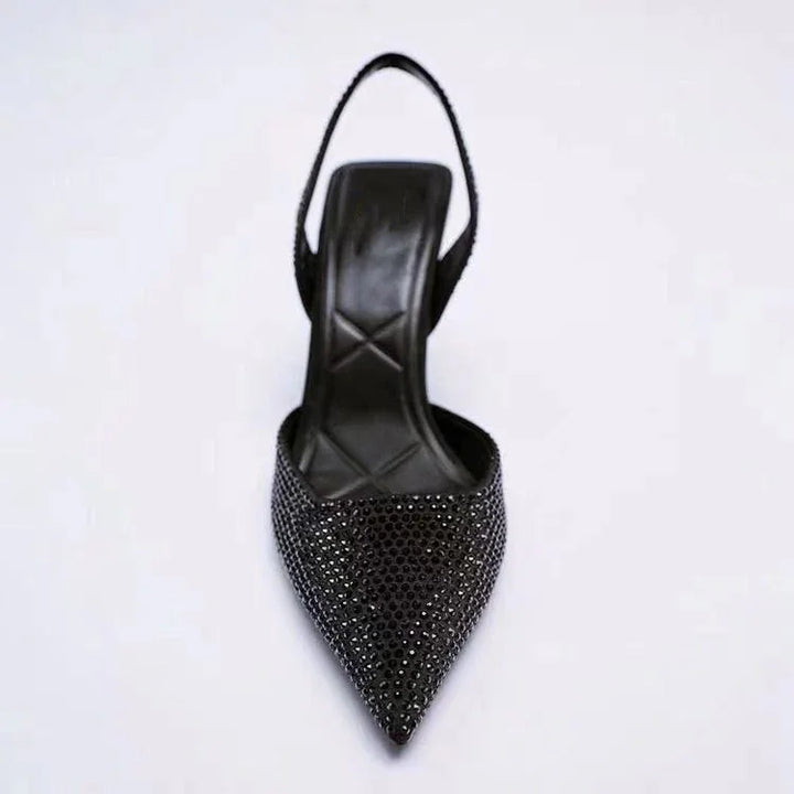 Black pointed-toe slingback shoe with sparkling rhinestone embellishments and cushioned insole