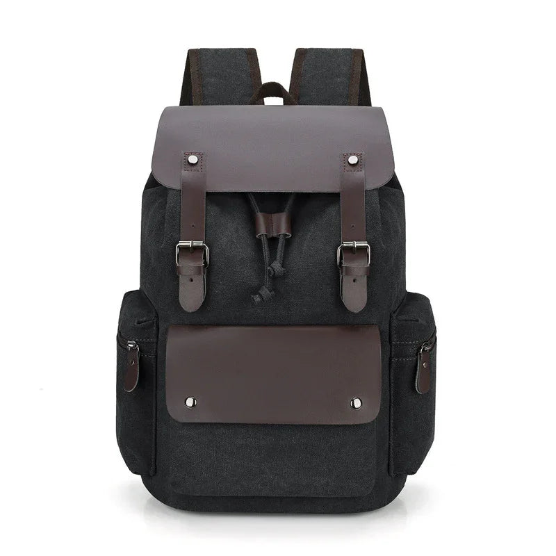 black canvas backpack with brown leather flap, buckles, and front pocket, side zippered compartments