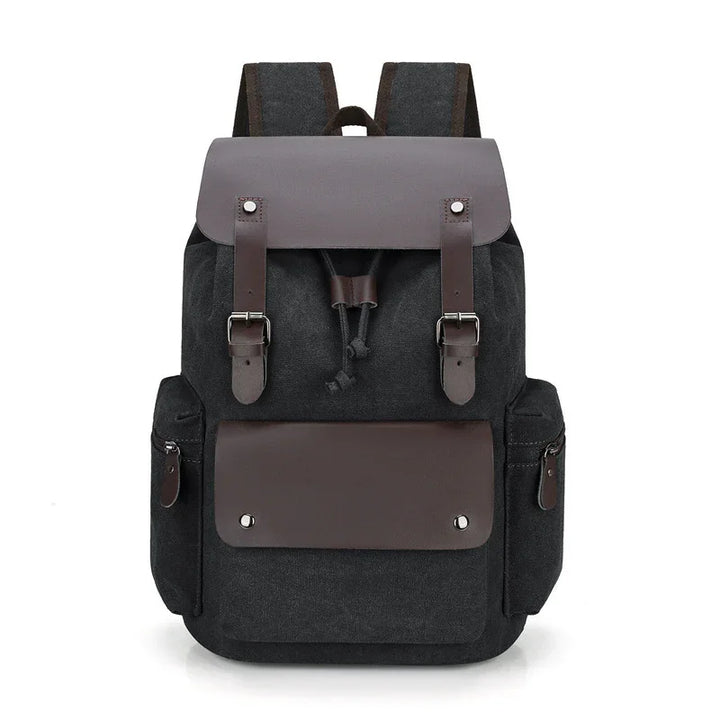 black canvas backpack with brown leather flap, buckles, and front pocket, side zippered compartments