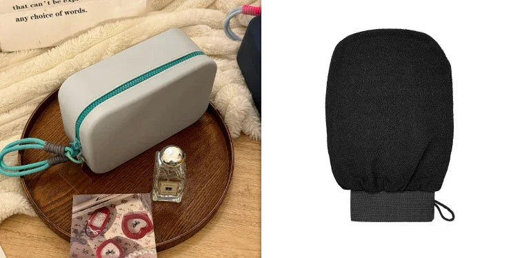 Gray pouch with teal zipper on wooden tray next to perfume bottle and face scrubbing mitt