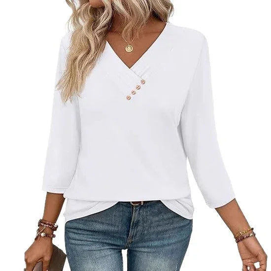 Woman wearing white V-neck blouse with three buttons and 3/4 sleeves paired with blue jeans