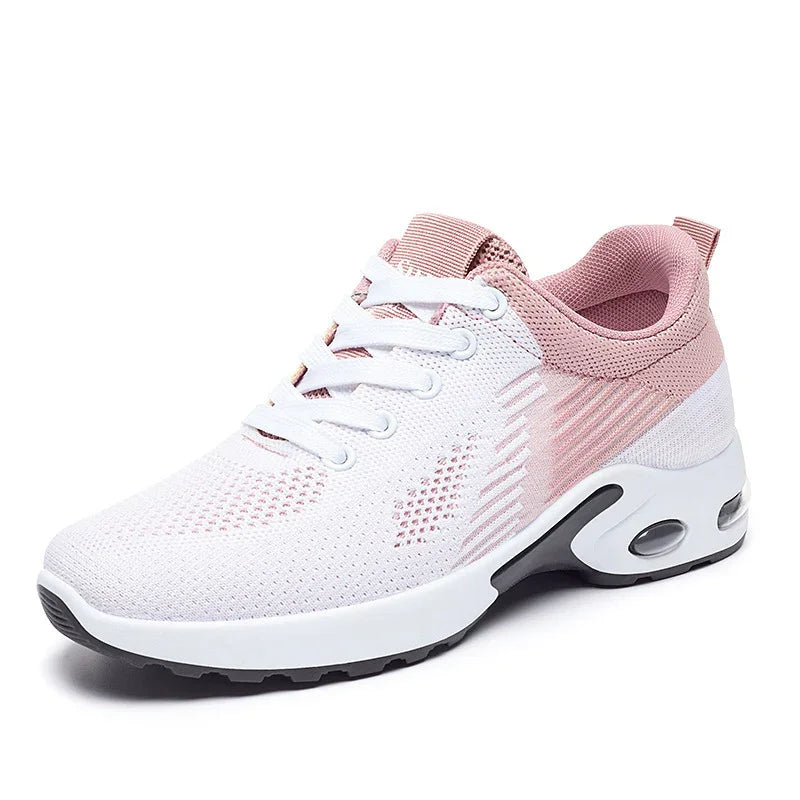 Women's white and pink breathable mesh athletic sneaker with cushioned sole and rubber outsole