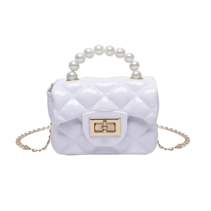 White quilted handbag with pearl handle and gold chain strap on white background