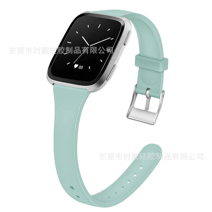 Silver frame smartwatch with mint green silicone strap showing analog time and heart rate