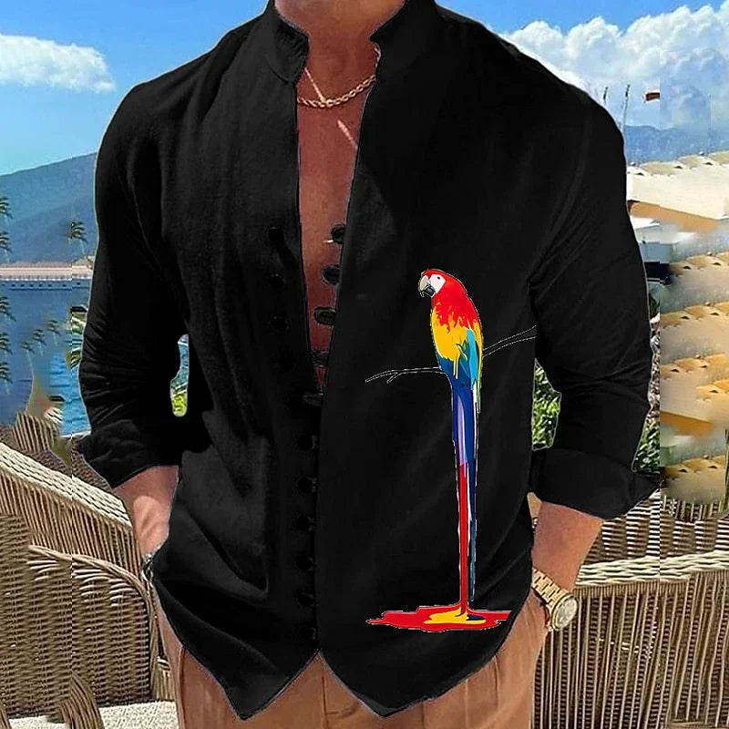 Man wearing black Mandarin collar shirt with colorful melting parrot graphic, outdoor patio and mountain background