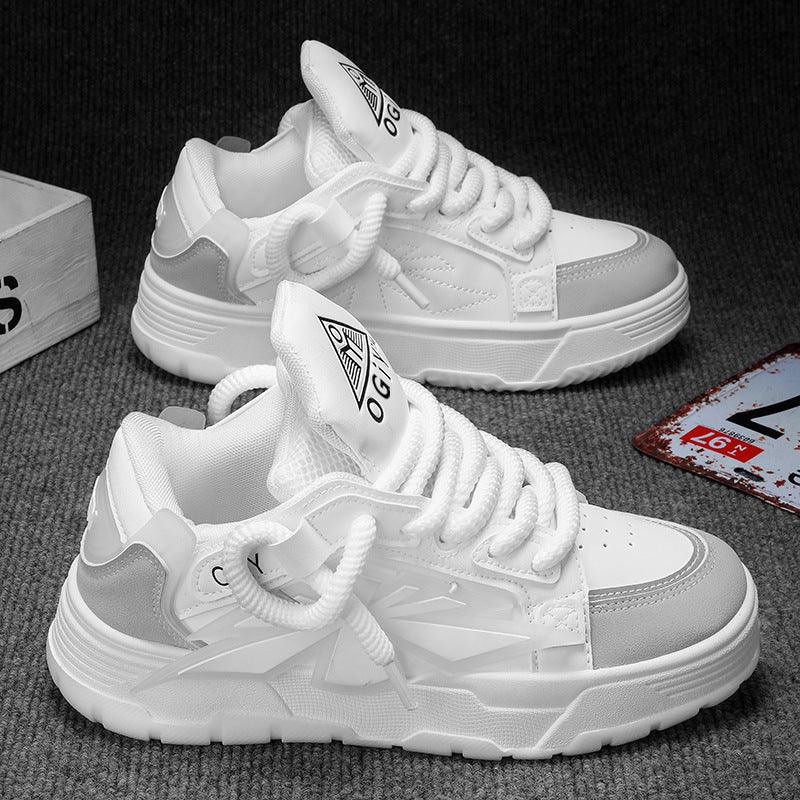 White and gray casual sneakers with chunky soles on gray carpet background