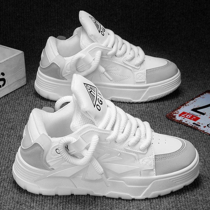 White and gray casual sneakers with chunky soles on gray carpet background