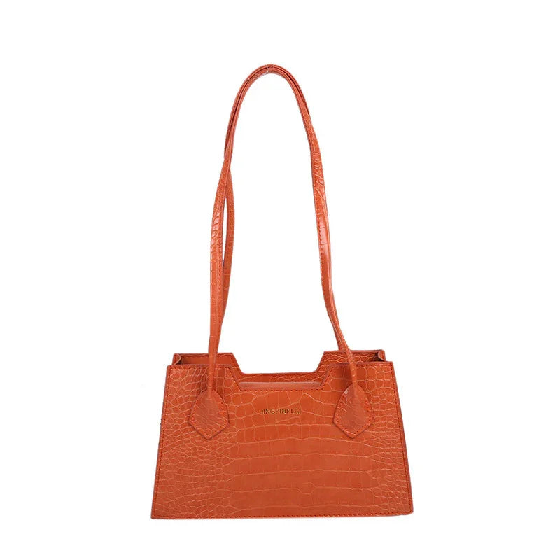 Orange crocodile pattern leather handbag with long straps and structured rectangular shape