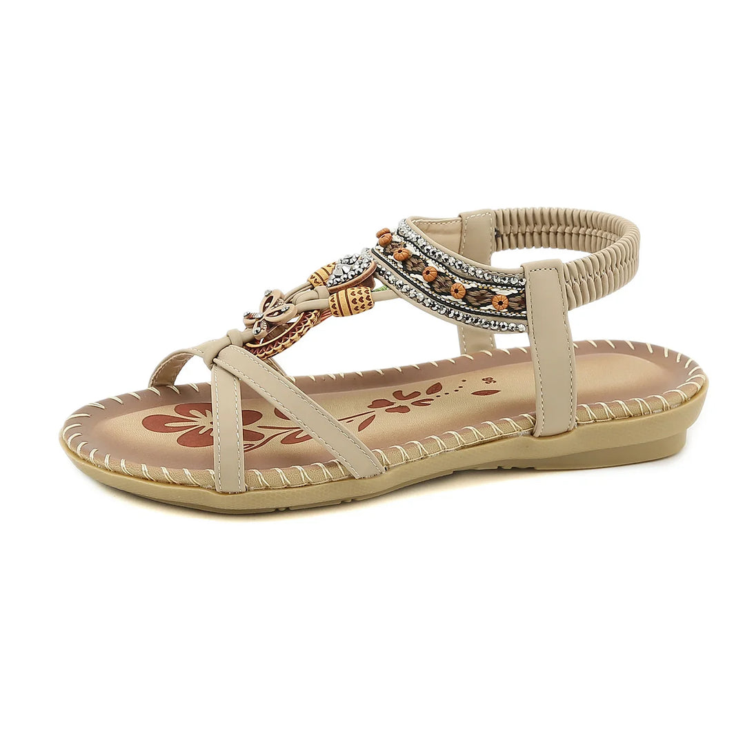 beige flat sandal with embroidered strap, beaded and rhinestone embellishments, floral insole design