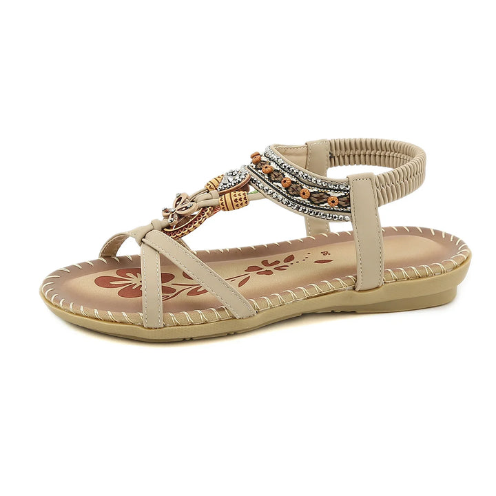 beige flat sandal with embroidered strap, beaded and rhinestone embellishments, floral insole design