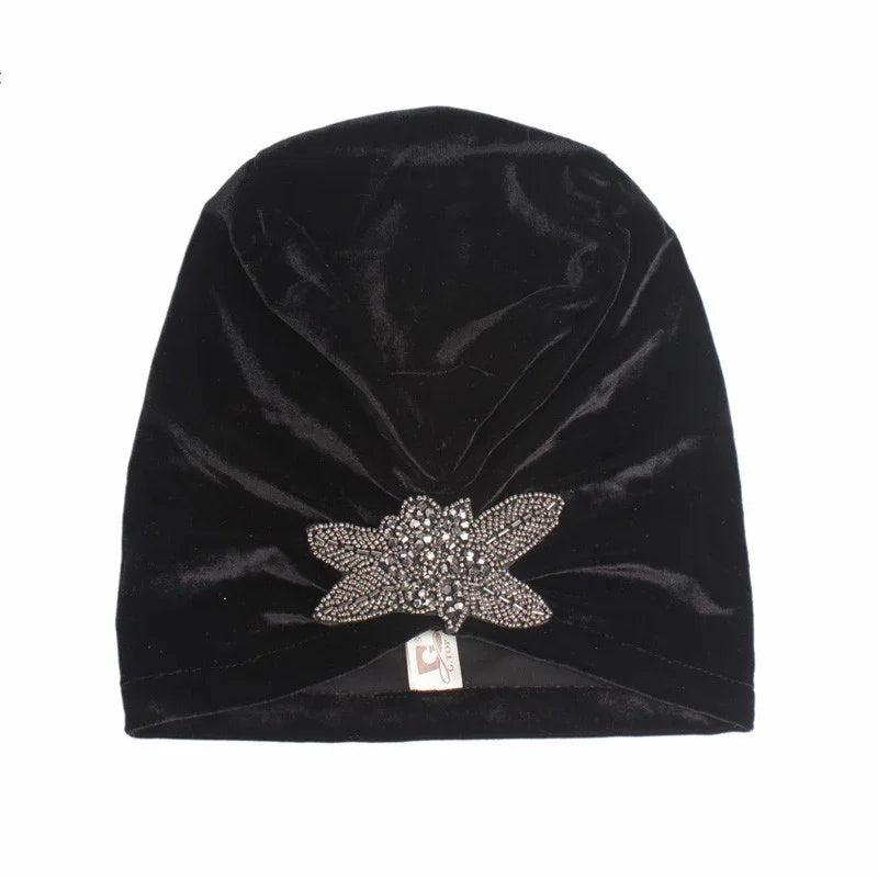 Black velvet turban hat with decorative rhinestone flower embellishment