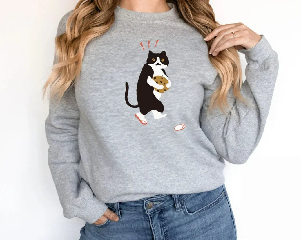 Gray sweatshirt with black and white cat graphic holding a cookie illustration
