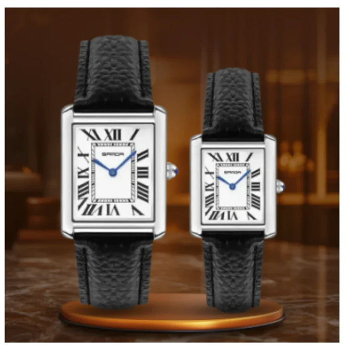 Pair of rectangular watches with black leather straps and white dials with Roman numerals on a brown background