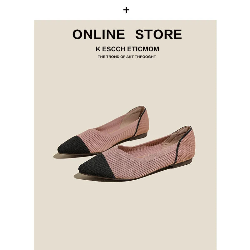 Pair of pink textured flat shoes with black pointed toe caps on beige background