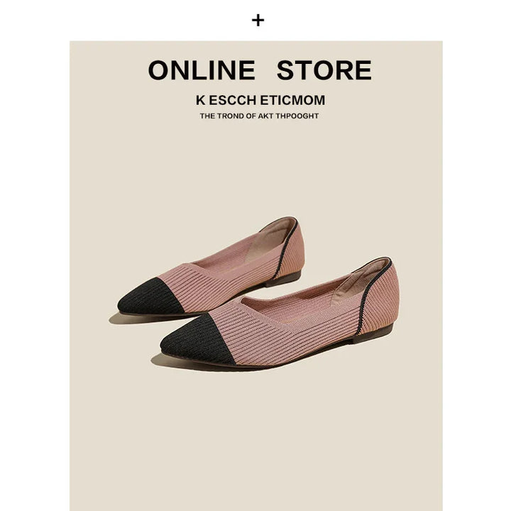 Pair of pink textured flat shoes with black pointed toe caps on beige background