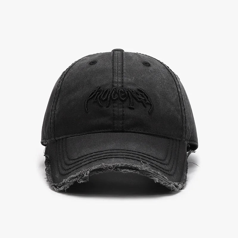 Front view of black distressed baseball cap with curved brim and embroidered logo
