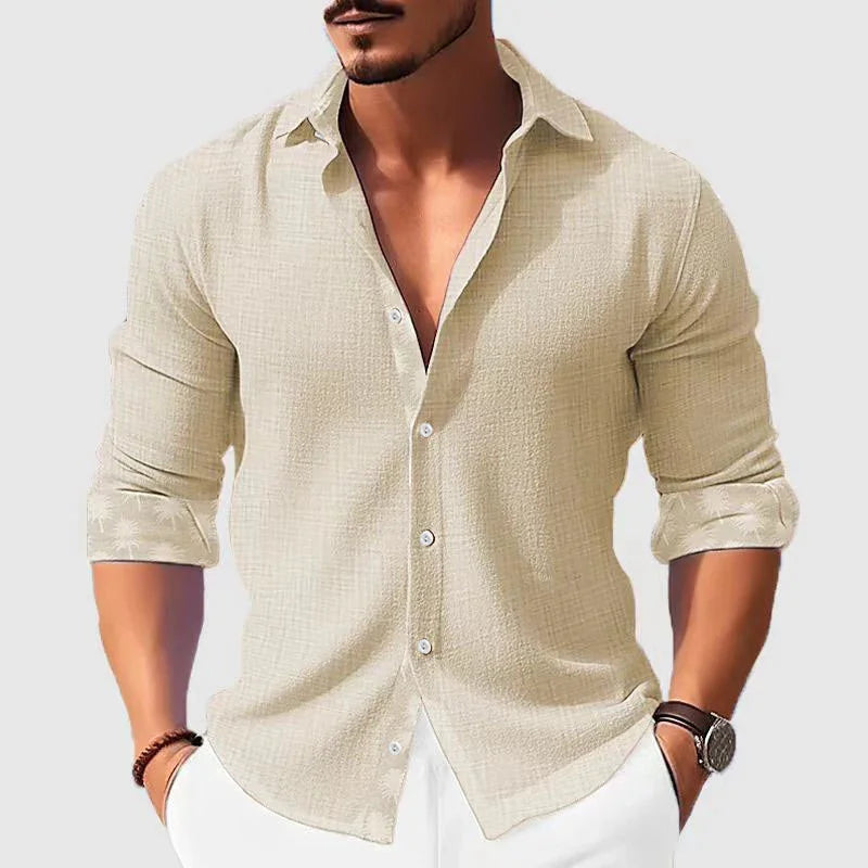 Man wearing beige textured long-sleeve shirt with rolled cuffs and white pants, casual style