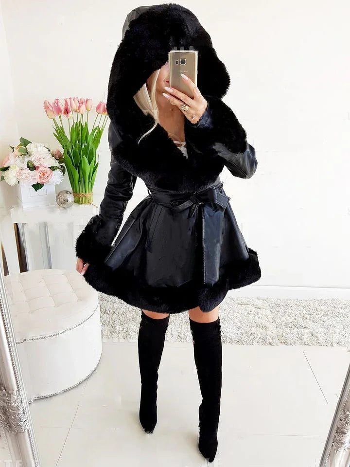Woman wearing a black faux fur-trimmed coat with hood and thigh-high black boots, taking mirror selfie
