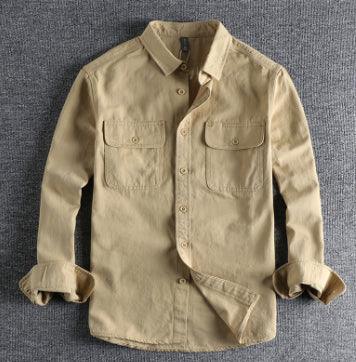 Beige casual long-sleeve button-up shirt with two chest pockets on grey fabric background