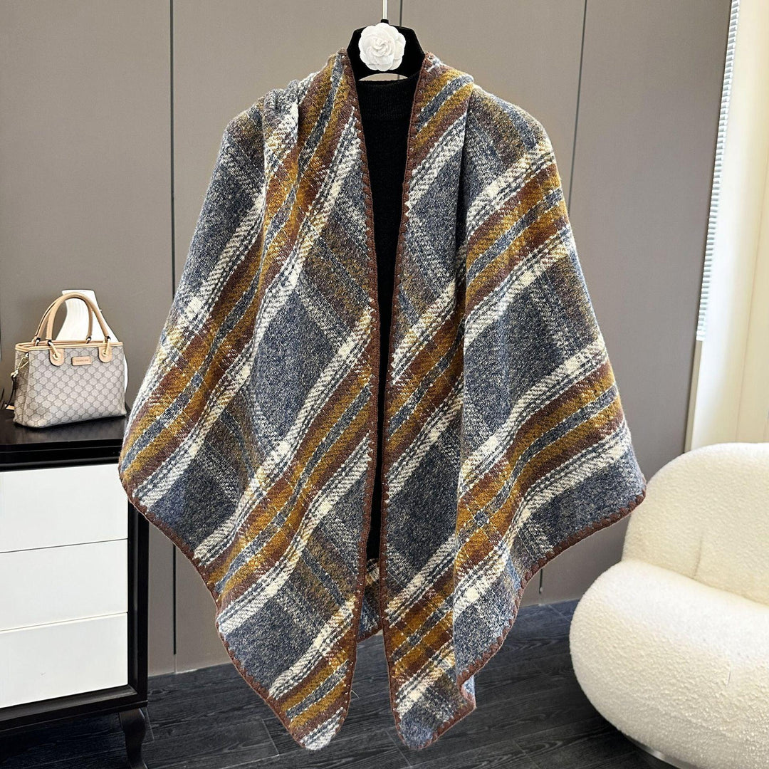 Plaid wool shawl with brown, white, and gray stripes displayed on mannequin in modern room
