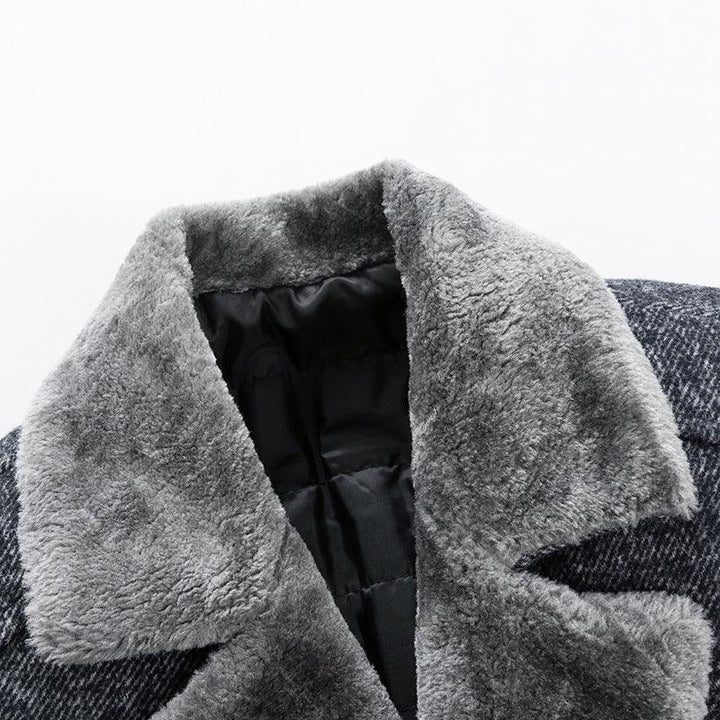 Close-up of gray faux fur collar on a black quilted jacket with textured fabric