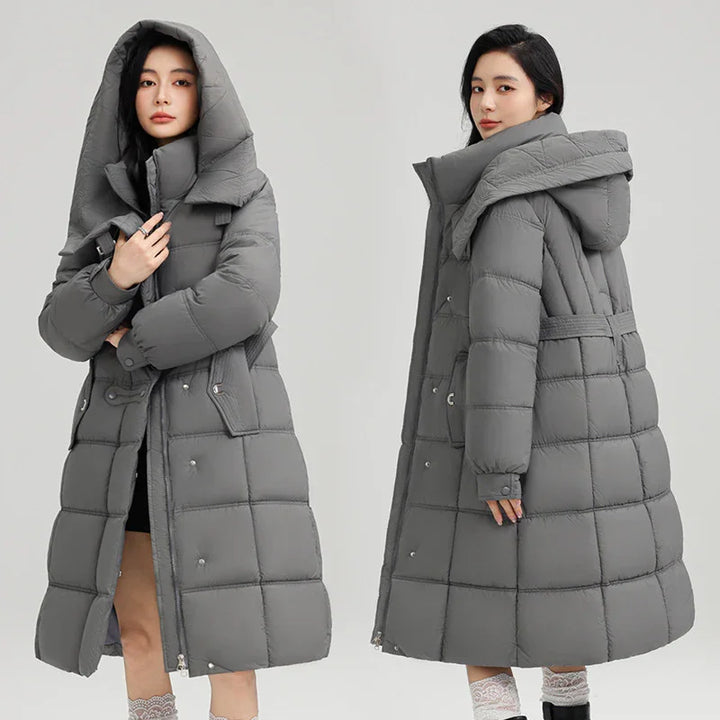 Woman wearing long gray padded winter coat with large hood, front and back views